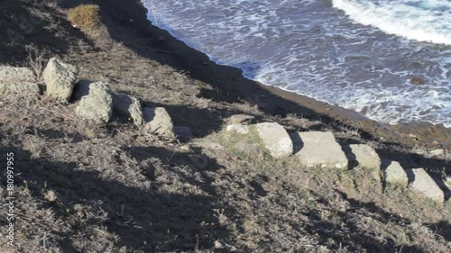 Steps leading down to sunken remains of harbot wall in the ancient Carian city of Myndos.