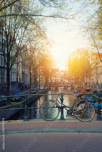 Bicycle on the bridge with Netherlands traditional houses and Amsterdam canal in Amsterdam ,Netherlands.