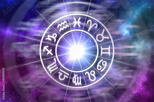 Zodiac signs inside of horoscope circle on universe background