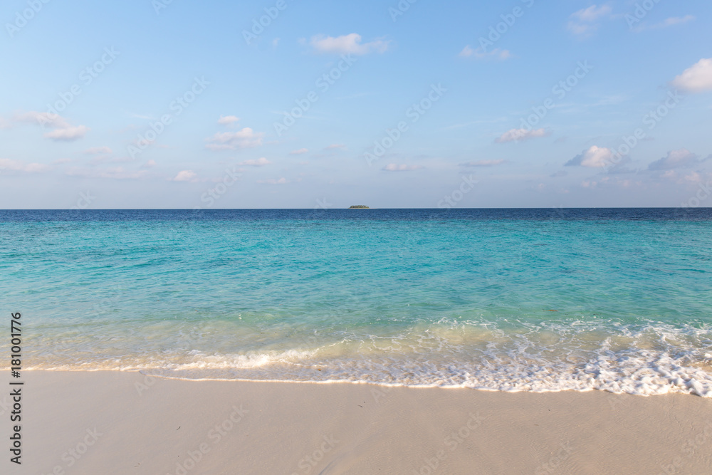 distant tropical island on a sunny day distant tropical island on a sunny day