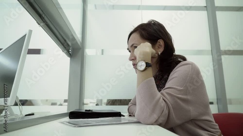 a woman passes documents for entering into a contract in the registration window. photo