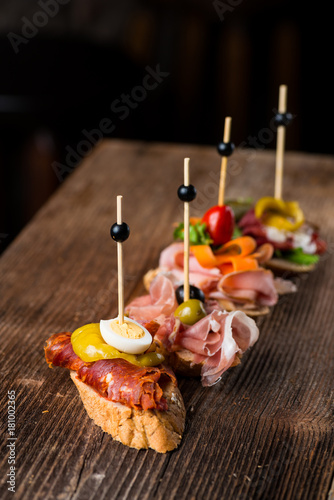 Tapas on Crusty Bread - Selection of Spanish tapas served on a sliced baguette.