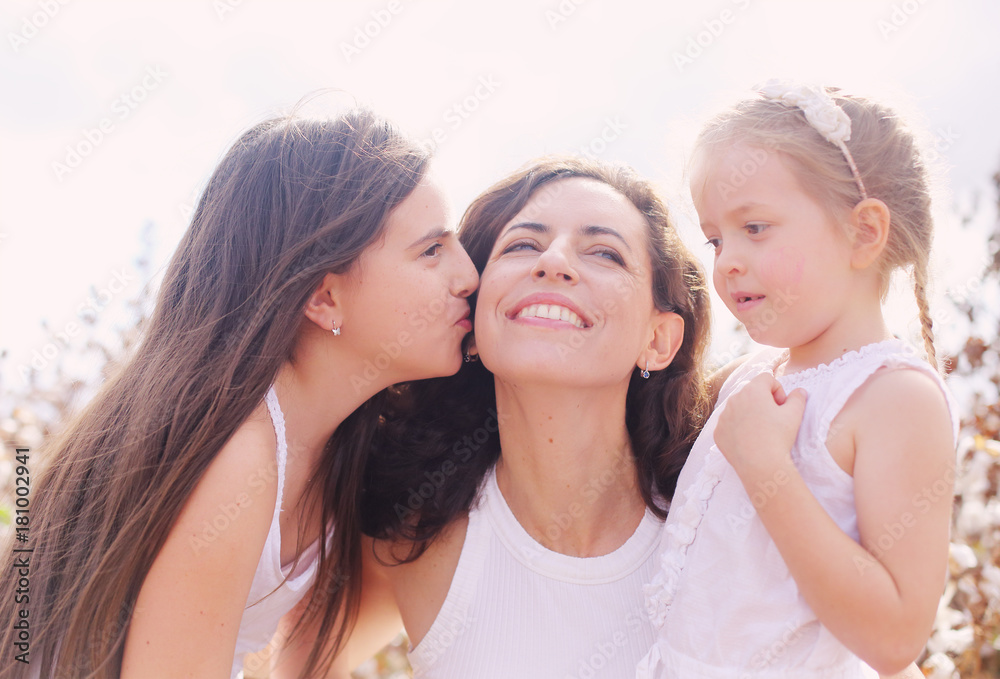 Portrait of beautiful mother with two daughters outdoors Portrait of beautiful mother with two daughters outdoors