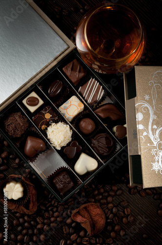 Luxury box of pralines received as a gift new a glass of brandy
