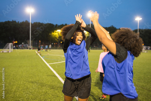 Female football players jubilant, Hackney, East London, UK
