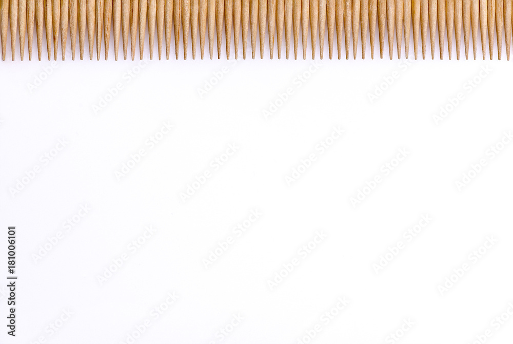 Toothpicks laid in a row horizontally 1/4 of the frame on a white background Toothpicks laid in a row horizontally 1/4 of the frame on a white background