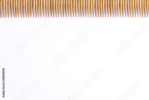 Toothpicks laid in a row horizontally 1 4 of the frame on a white background