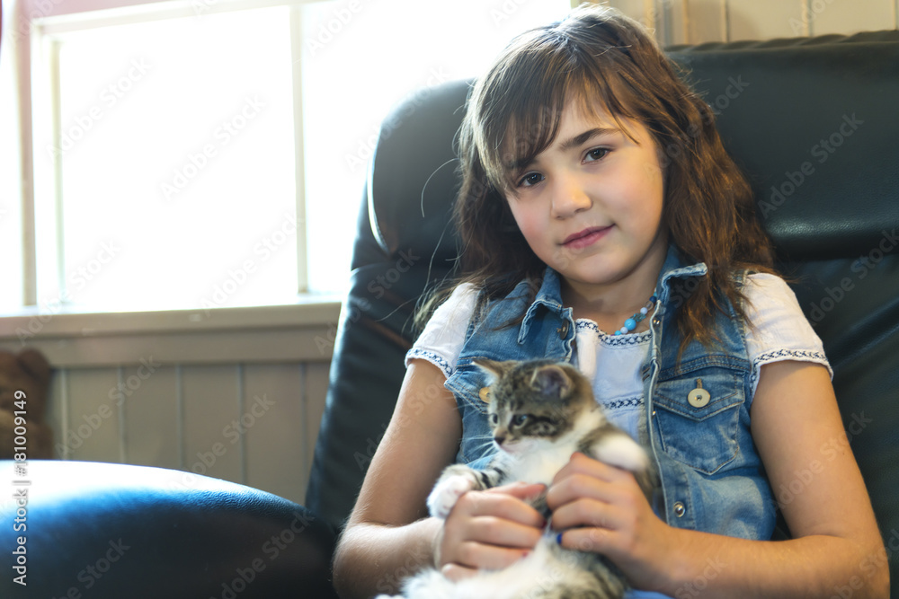 7 years old girl with kitten at home 7 years old girl with kitten at home