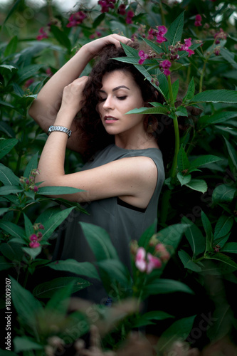 brunette posing in green high grass