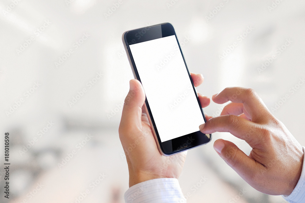 Smartphone blank screen in business man hands in blurred office interior background.