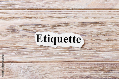 etiquette of the word on paper. concept. Words of etiquette on a wooden background photo