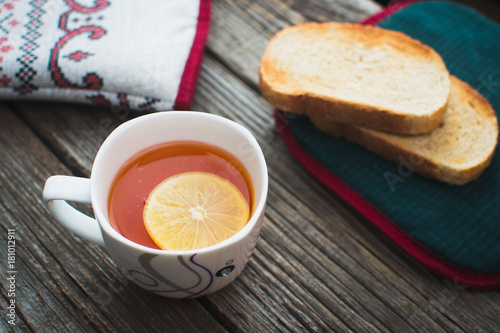 On wooden background, on the boards of toasted bread with tea and cakes