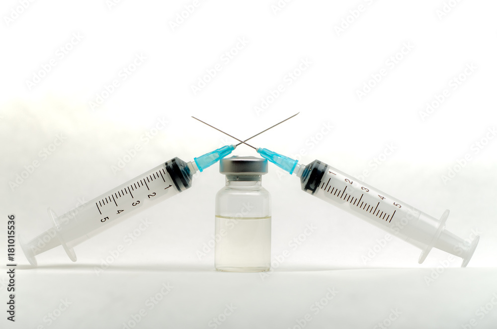 A medical syringe recruits a vaccine from an ampoule A medical syringe recruits a vaccine from an ampoule