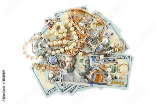 Gold jewelry and dollars isolated on white background.
