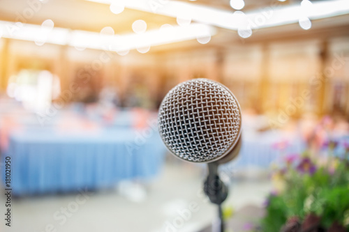 Blurred of microphones in seminar room, talking speech in conference hall light with microphone and keynote. Speech is vocalized form of communication humans, vintage tone