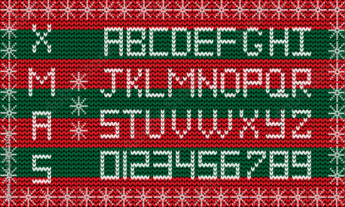 White knitted alphabet and numerals on red and green striped knitted fabric background framed with snow flakes. Fabric Christmas or New Year script. Knit festive winter alphabet.