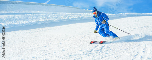 Young athlete skiing in alps mountains on sunny day