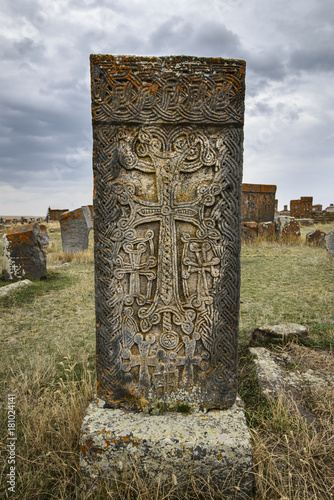 Khachkar is a free-standing cross made of stone and richly decorated. An Armenian cross is a symbol that combines a cross with a floral postament or elements. This one is placed on Noratus cemetery. photo