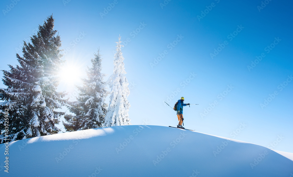 Full length shot of a skier on top of the mountain, pointing to the sky. copyspace active people living leisure hobby extreme slope snow winter seasonal sport