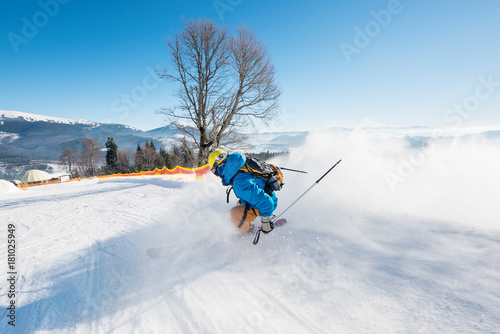 Rearview shot of a skier riding down the slope at ski resort in the Carpathians mountains copyspace seasonal activity sport sportsman hobby recreation travel concept