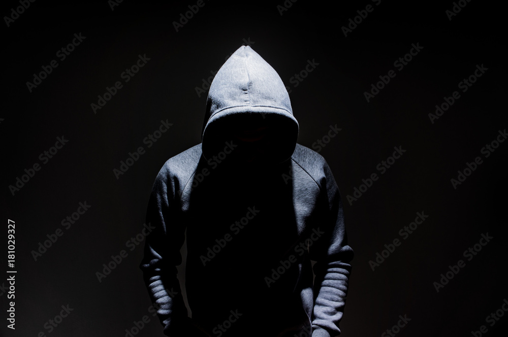 Silhouette of man in the hood, dark mysterious man hoodie, murderer,  hacker, anonymus on the black background with free space Stock Photo |  Adobe Stock