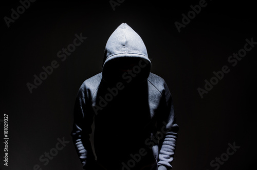 Fototapeta Silhouette of man in the hood, dark mysterious man hoodie, murderer, hacker, ano