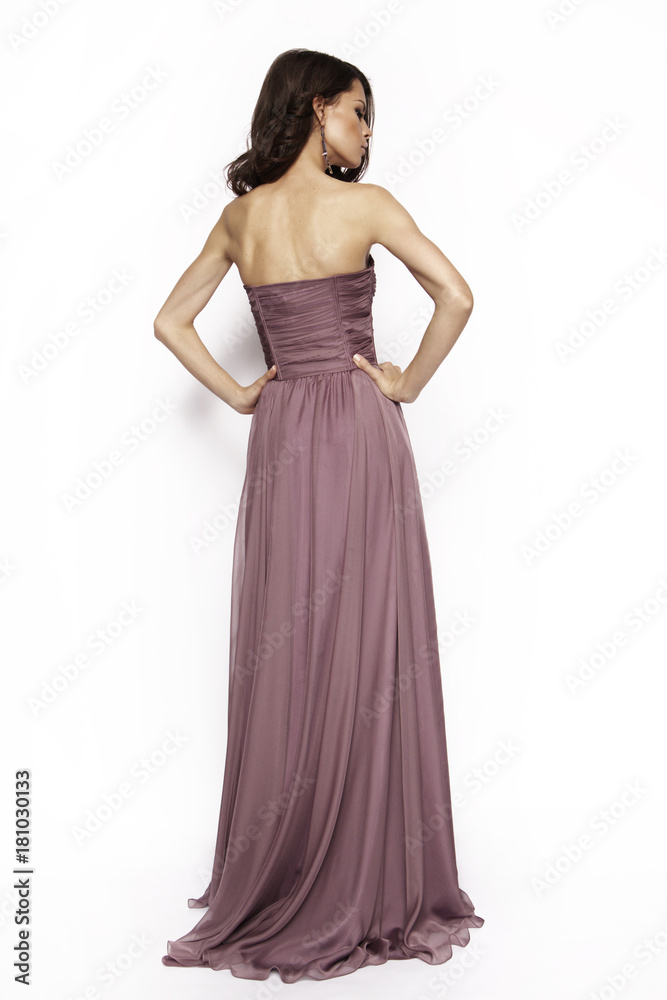 Brunette in a long dress posing