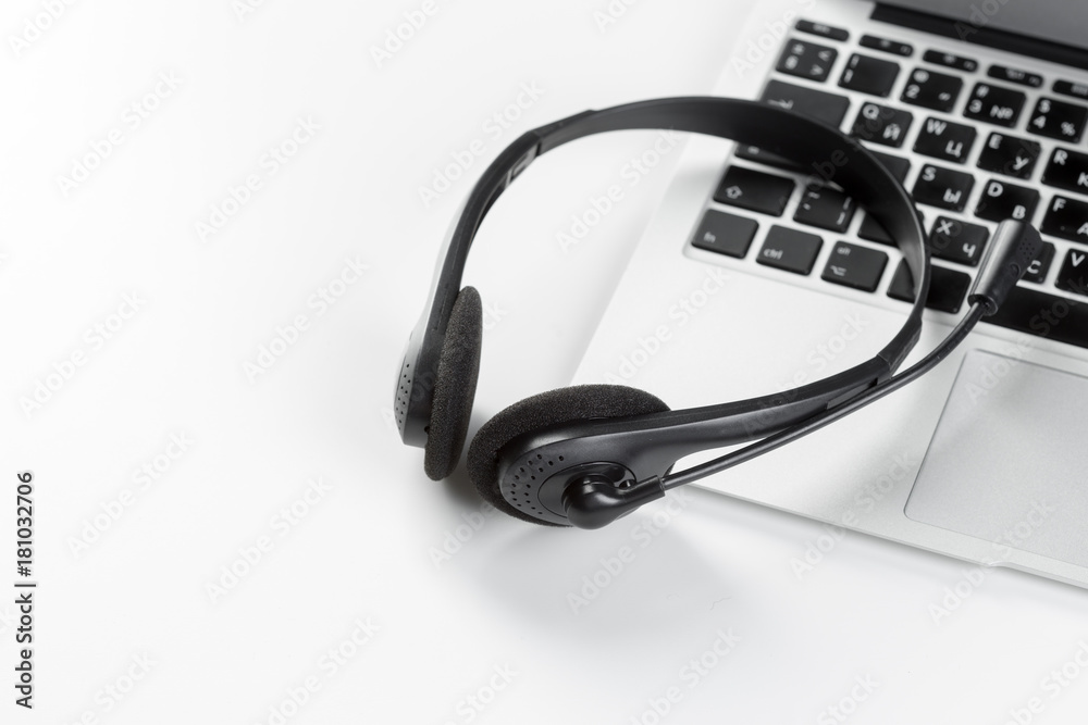 call center support concept. headset on keyboard computer laptop call center support concept. headset on keyboard computer laptop