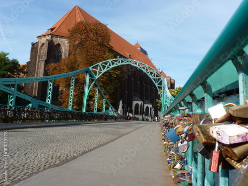 Tumski bridge and Church of Our Lady on Sand in Wroclaw. Poland. Padlock on the bridge.