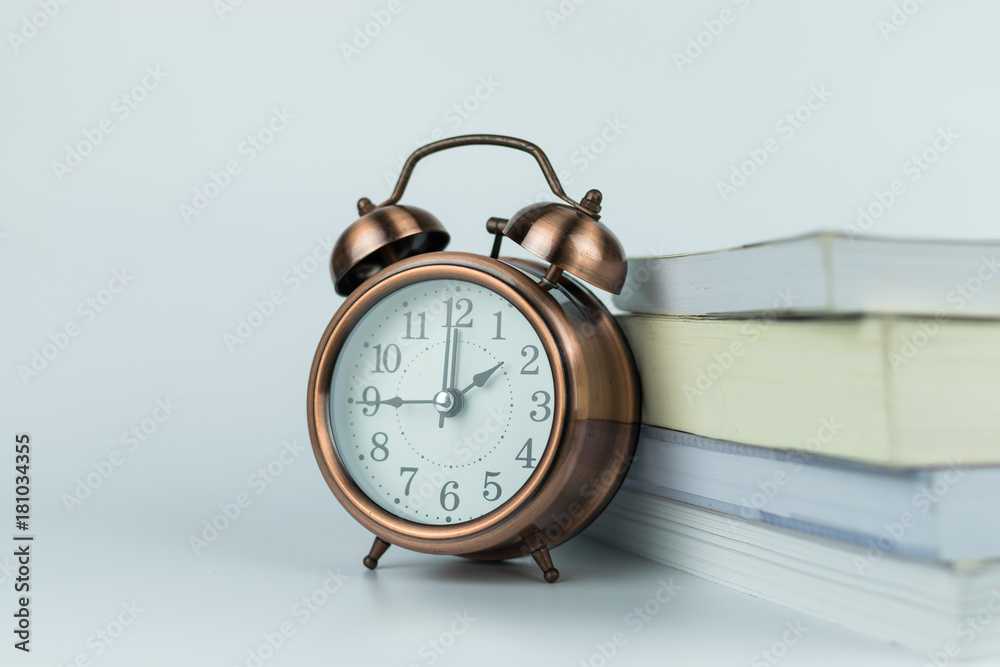 Naklejka premium alarm clock and book