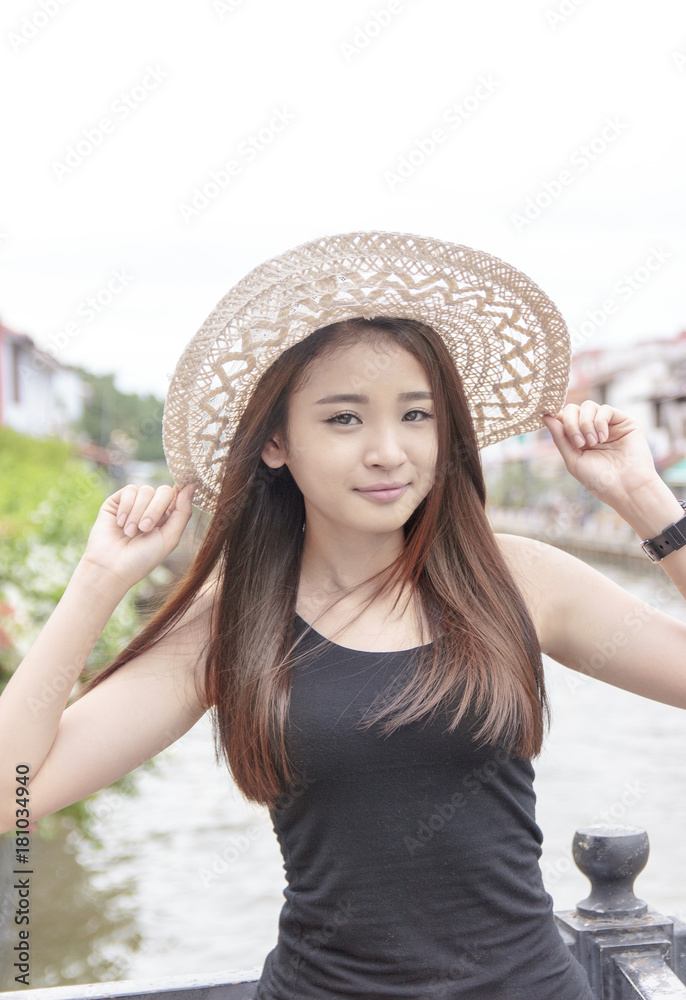 Beautiful asian woman posing in Melaka river