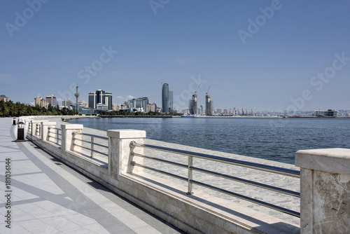 Azerbaijan, Caspian Sea, Baku: Strolling promenade with cityscape of the capital and blue sky in the background.