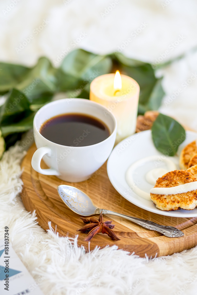 Breakfast. Lunch. Pancakes with cream. Candle and coffee. Cup of coffee with pankaces