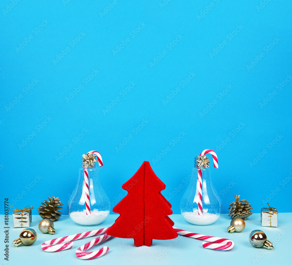 Christmas composition with Santa, decorative christmas tree, gifts and candy canes.