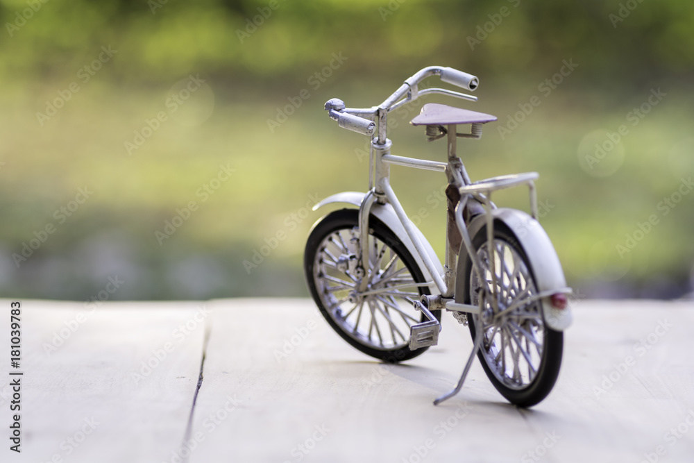 Bicycle toy models on wooden floor with sunshine