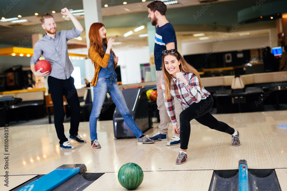 Friends enjoying bowling at club Friends enjoying bowling at club