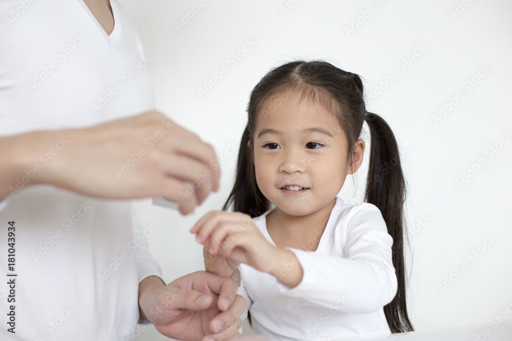 Attractive Little Girl looking to hand's dad. Dad Teaching her at home. Children Lifestyle, Education Concept.