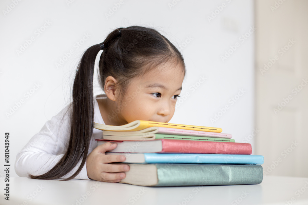 Attractive Little Girl holding Book with smiling. Happy Children Lifestyle, Education Concept. Attractive Little Girl holding Book with smiling. Happy Children Lifestyle, Education Concept.