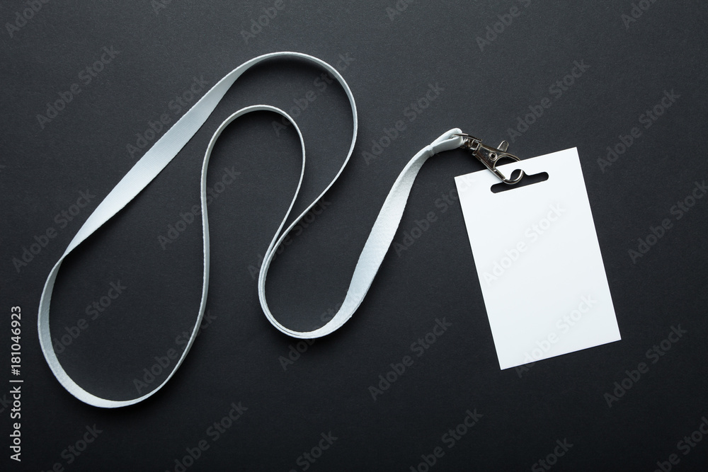 Blank badge mockup isolated on black. Plain empty name tag mock up hanging on neck with string. Name Tag, Corporate design. - obrazy, fototapety, plakaty 