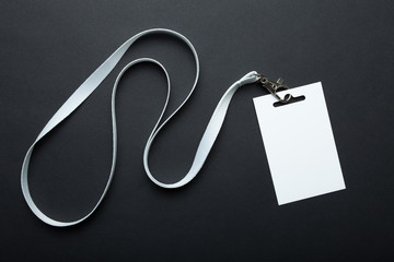 Blank badge mockup isolated on black. Plain empty name tag mock up hanging on neck with string. Name Tag, Corporate design.