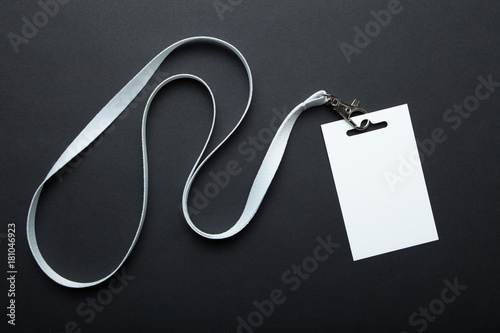 Blank badge mockup isolated on black. Plain empty name tag mock up hanging on neck with string. Name Tag, Corporate design. photo