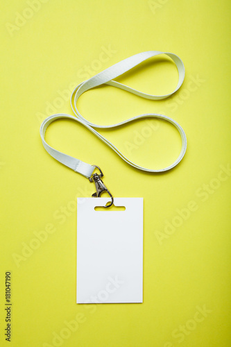 White blank ID card tag with ribbon on yellow background, mockup.