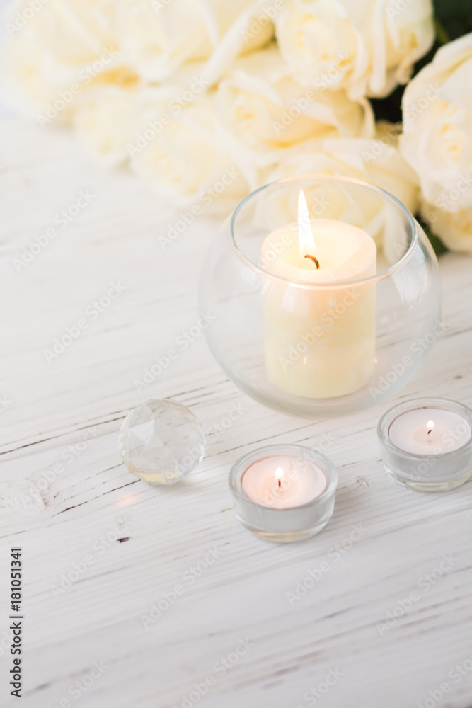 Big palm candle in glass ball with white roses