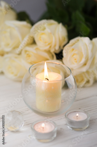 Big palm candle in glass ball with white roses