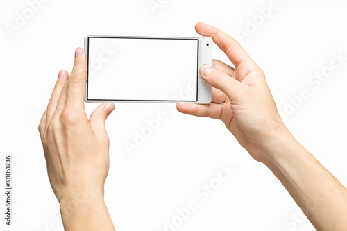 Mockup of female hands holding frameless cellphone with blank screen and making selfie at isolated background.