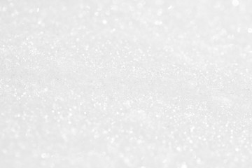 The background is white. The texture of the brilliant snow for the New Year's postcard.