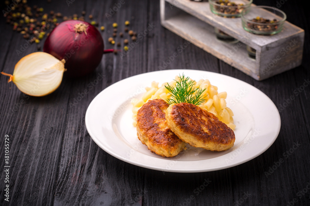 Delicious meatballs cutlets with garnish on black rustic wooden background. Delicious meatballs cutlets with garnish on black rustic wooden background.