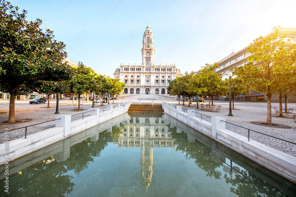 Morning view on the city hall building with reflection in the fountain on the central square in Porto city, Portugal