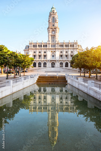 Morning view on the city hall building with reflection in the fountain on the central square in Porto city, Portugal