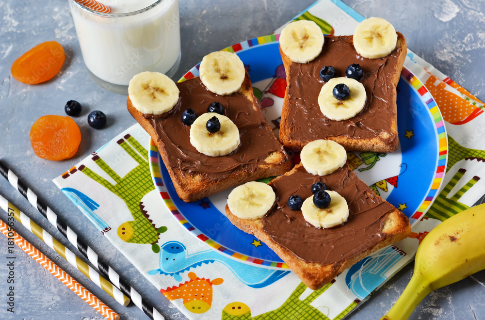Breakfast for children - toast with chocolate paste, banana and berries. Good morning!